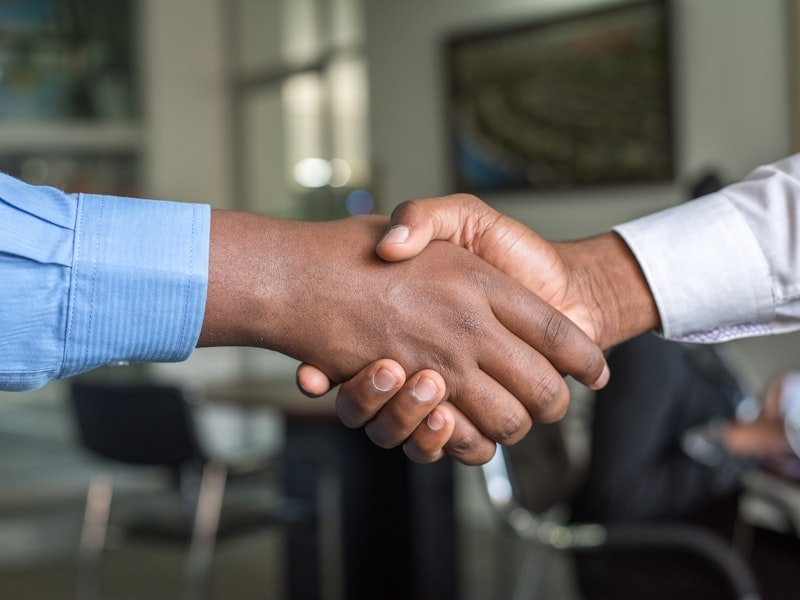 Disciplined Agile certified practitioner shaking hands at corporate meeting